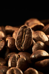 Roasted coffee beans isolated close up on black background, clipping path