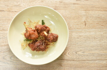 spicy fried chicken with chili and slice lemon grass on dish