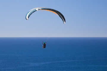 Hang glider in the blue sky