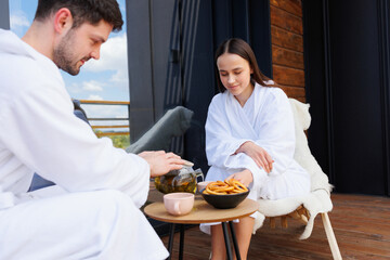 Young couple having tea after spa treatments