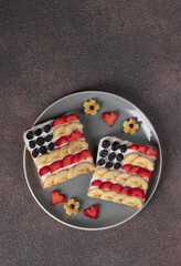 American flag sandwiches with fruit and cream cheese on rye bread. Independence Day breakfast idea. Top view