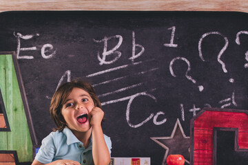 Fototapeta premium back to school kid pre k child in front of board chalk chalkboard a b c 