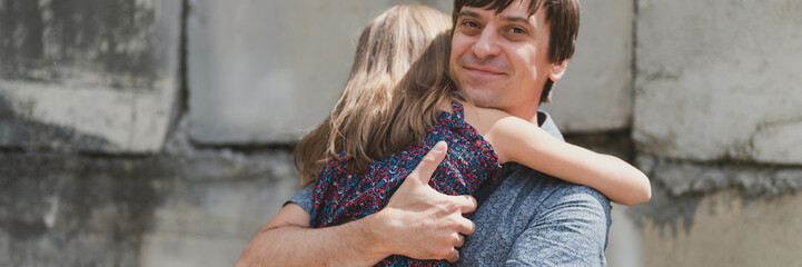man dad having quality time with their kid daughter girl nine year old hug on his arms. happy father playing with child. real life authentic day-to-day fatherhood moments. fatherly love care. banner - obrazy, fototapety, plakaty