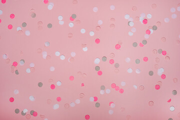 Party colorful confetti over pink background . Top view, flat lay