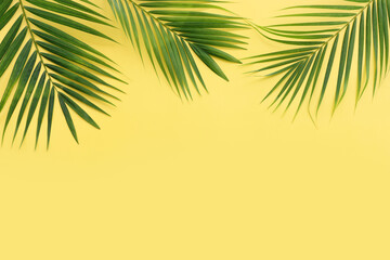 Fototapeta na wymiar Image of tropical green palm over yellow pastel background