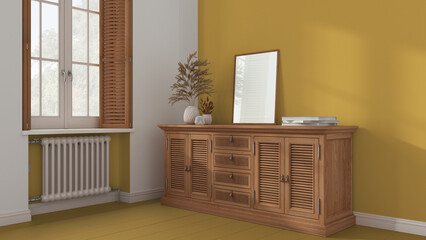 Retro living room with yellow painted wooden floor and walls. Rattan chest of drawer with decor. Frame mock up. Window with shutters and radiator. Vintage interior design