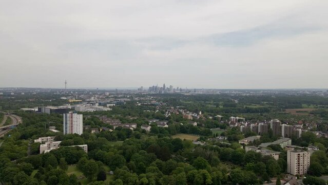 Aerial footage of the cityscape of Frankfurt am Main on a cloudy spring day. Fast wide angle pull back shot