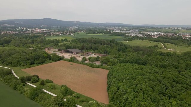 Aerial orbit around an abandoned military airfield on a cloudy spring day in Germany. Wide angle drone footage