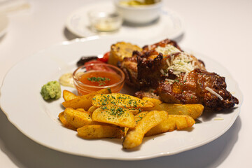 plate of grilled chicken with potatoes isolated