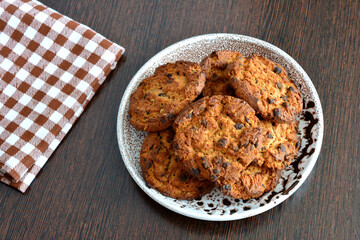 american cookies on plate on dark wooden background, close-up