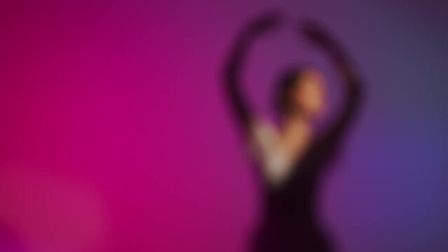 Blurred image, silhouette. Bright colors, rehearsal before performing at a concert. Behind the scenes, dancers, ballerinas preparing take stage. Assistants help, complete image. Art dance, theater