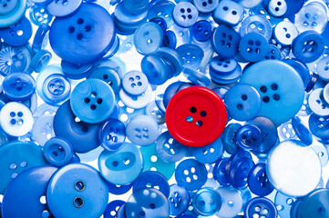 background of blue buttons and one red, thinking different concept