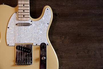 Fototapeta na wymiar Yellow guitar on old wood surface