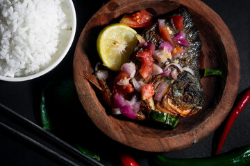 Fototapeta na wymiar lunch menu with fried pomfret and rice bowl. Asian food Photo concept