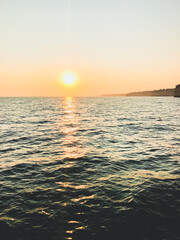 Fototapeta premium beautiful summer vacation sunset background and reflection over the sea and waves