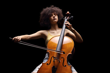 Female artist playing a cello isolated on black