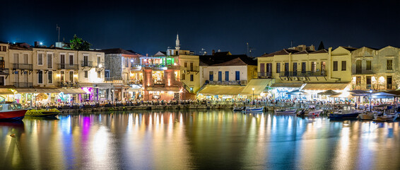 Fototapeta na wymiar Terrace of restaurant full of people in port of Rethymno city -Crete, Greece
