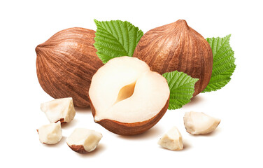 Hazelnuts without nutshell with small broken pieces and leaves.