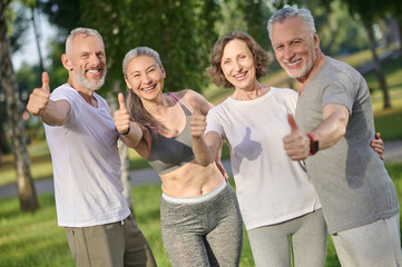 Group of people spending time together in the park and looking happy