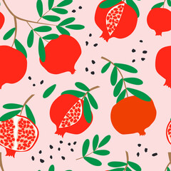 Ripe red pomegranates on a branch with green leaves. Seamless pattern with pink background for fashion textiles. 