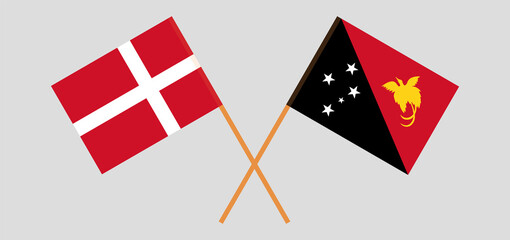 Crossed flags of Denmark and Papua New Guinea. Official colors. Correct proportion