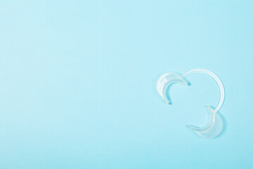 Retractor Dental lip retractor Access to the oral cavity. Wide mouth opening for a dental procedure on a clean blue background