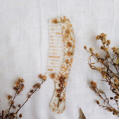 handmade floral comb on white fabric
