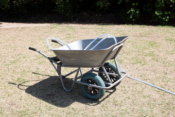 Garden cart with old grass on the lawn.