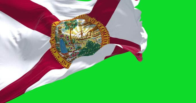 The Florida state flag waving in the wind on a clear day