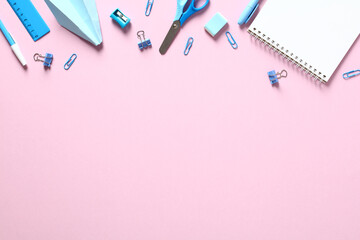 Creative layout with blue school supplies on pink background. Flat lay, top view, overhead. Minimal style.