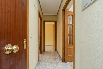 Hallway of a house with light wood carpentry with glass doors and ceramic stoneware floors