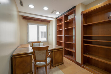 Professional office with tables for office workers, with matching wooden chairs and file area with wooden shelves