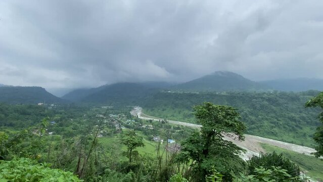 Ultra wide shot of India Bhutan border at Jhalong , Dooars - West Bengal , India in a cloudy day.