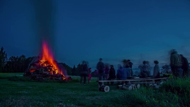 Midsummer Celebration At Night. Time Lapse Bonfire And People Relax.