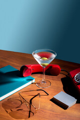 Cocktail in a tall glass for vermouth on the background of retro things. Concept of mixology and...