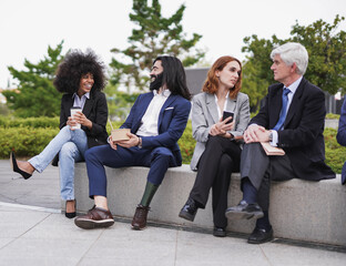 Multiracial business people eating fresh poke food during lunch break outside - Focus on the man with prosthetic leg