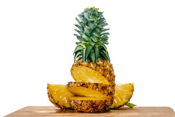 Fototapeta na wymiar sweet yellow ripe pineapple sliced ​​on wooden table white background