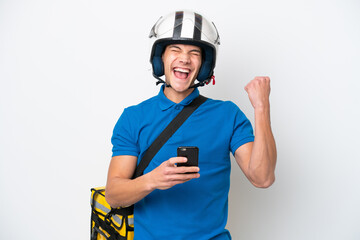 Young caucasian man with thermal backpack isolated on white background with phone in victory position