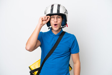 Young caucasian man with thermal backpack isolated on white background with glasses and surprised