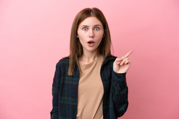 Young English woman isolated on pink background intending to realizes the solution while lifting a finger up