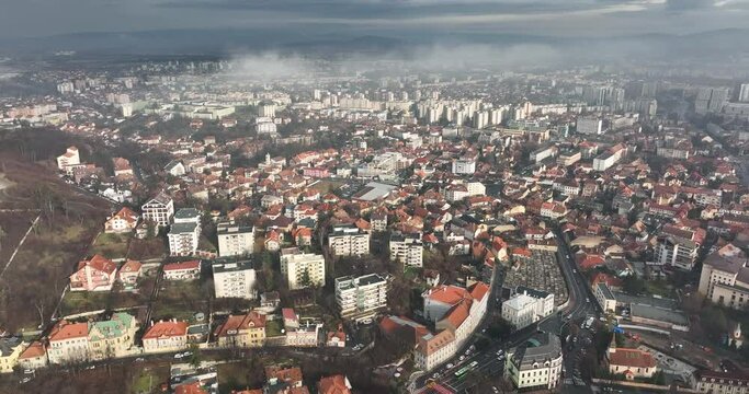 Brasov City under a cloud of fog. Aerial view. Reveal shot. The old architecture