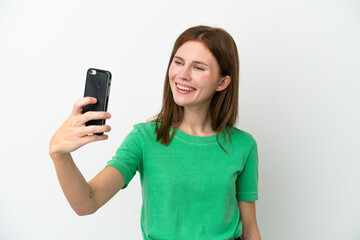 Fototapeta premium Young English woman isolated on white background making a selfie with mobile phone