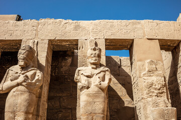 Statues of ancient Egyptian pharaohs and gods. Various hieroglyphs on the walls. Karnak temple is...