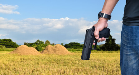 9mm automatic pistol holding in right hand of shooter, concept for security, robbery, gangster,...