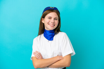 Airplane stewardess English woman isolated on blue background keeping the arms crossed in frontal...
