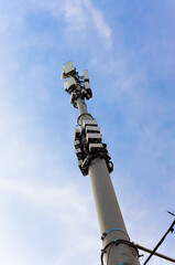 Telecommunication tower of 4G cellular against blue sky background. Base Station and mobile phone transmitters. Radio network telecommunication equipment.