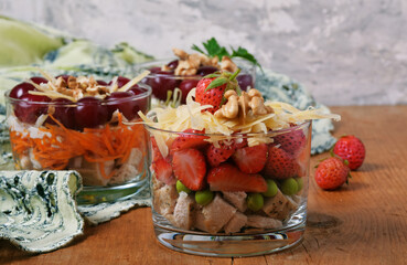 Different salads in three glasses. With meat, without meat, with fruits and nuts