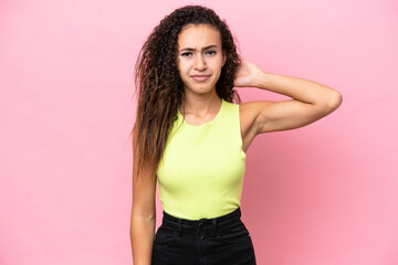 Young hispanic woman isolated on pink background having doubts