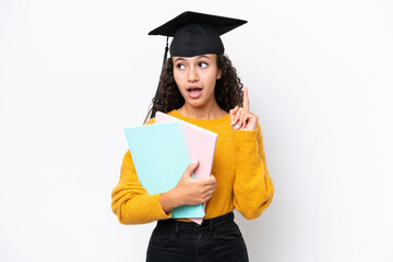 Arab university graduate woman holding books isolated on white background thinking an idea pointing...