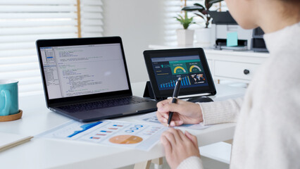 Fototapeta premium Back rear view of young asian woman, freelance data scientist work remotely at home coding programing on Big data mining, AI data engineering, IT Technician Works on Artificial Intelligence Project.